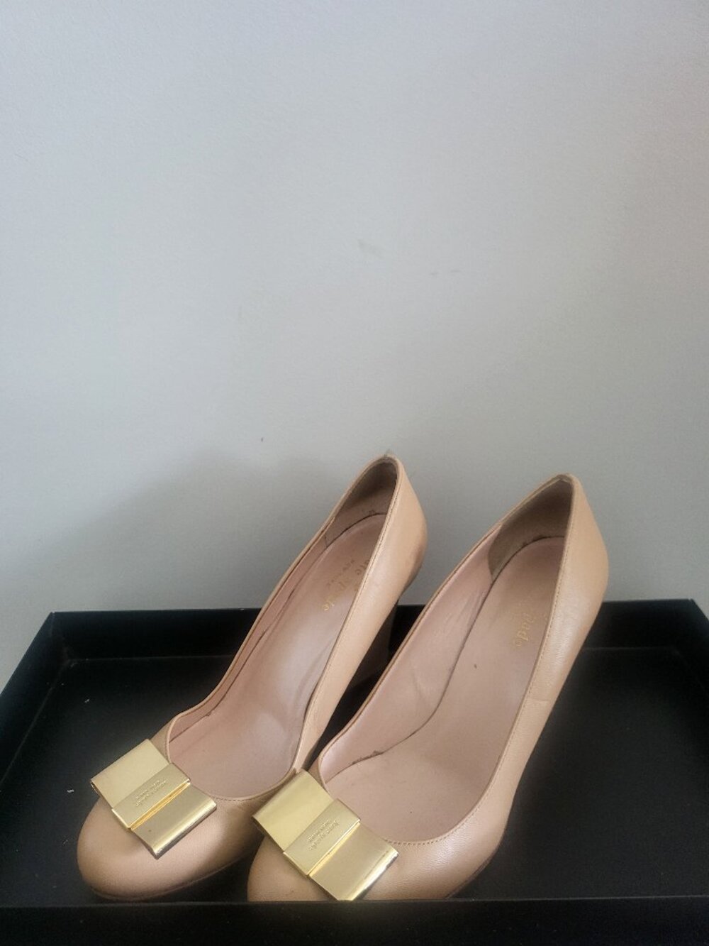 Kate Spade women's wedge heels featuring signature golden metal bow detail